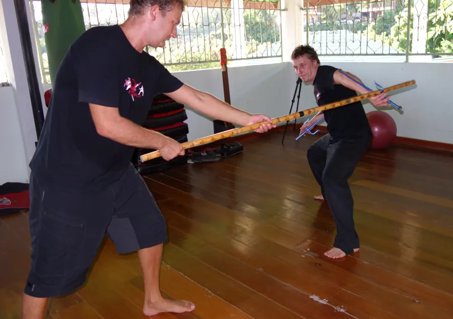 An instructor shows a student a staff move