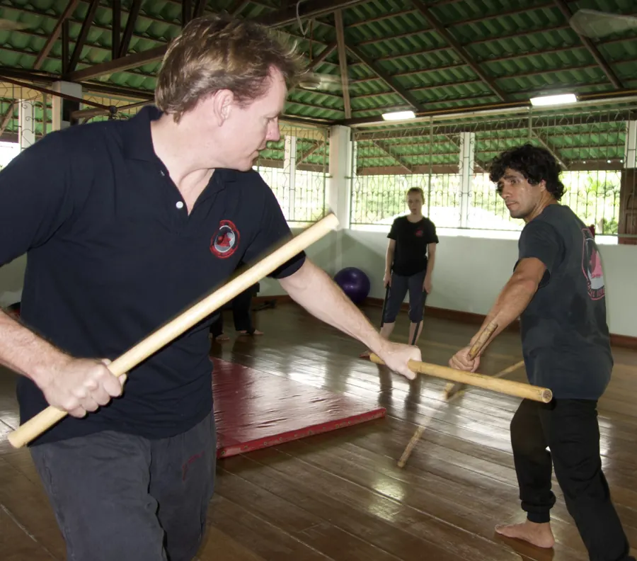 Rick Tew works a stick drill with a student