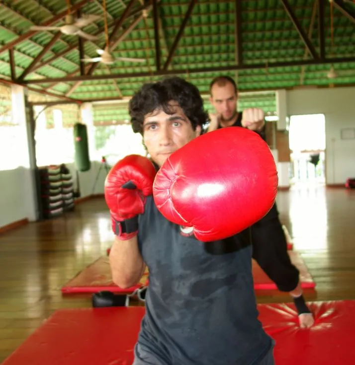 A student in red boxing gloves throws a punch
