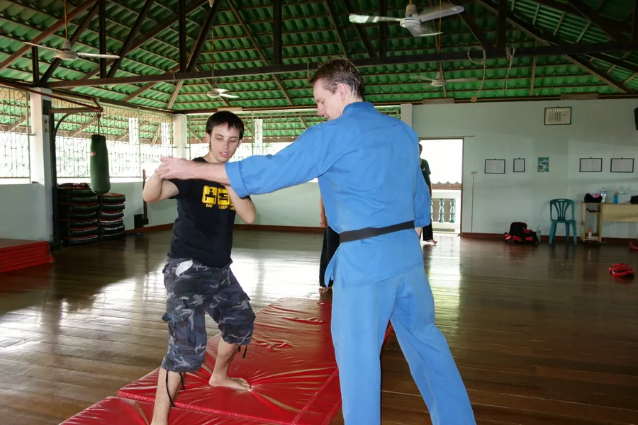 Rick Tew in a blue uniform shows a lock on a student