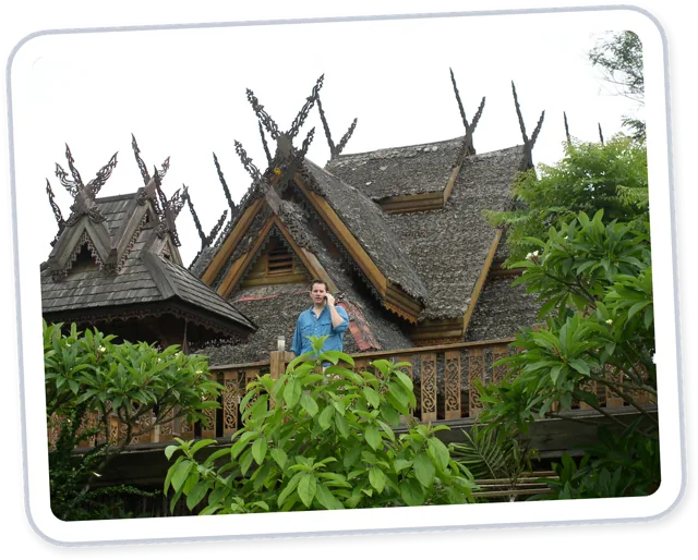 Rick Tew on the balcony of a carved wooden treehouse in Pai, in the mountains of northern Thailand